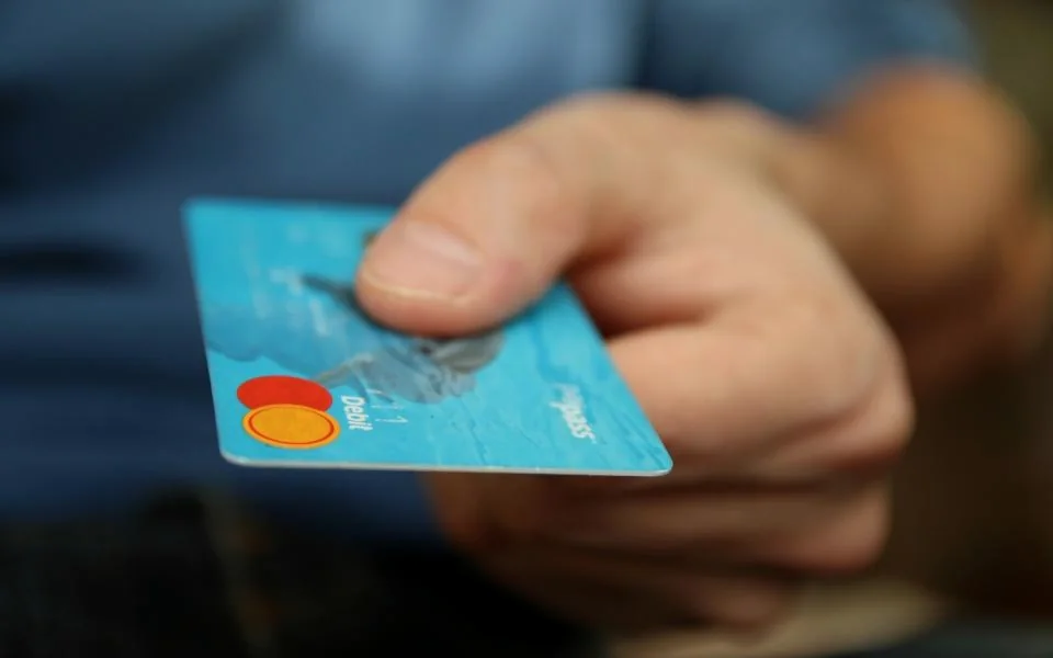 A hand holding a bank card